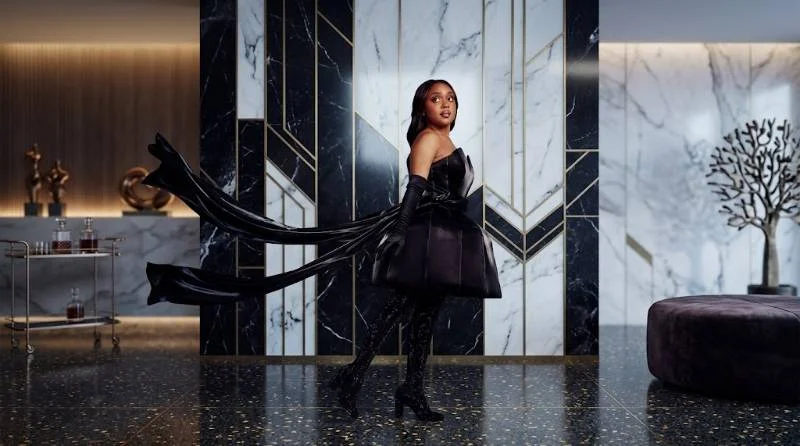 Quinta Brunson on a school hallway set between takes