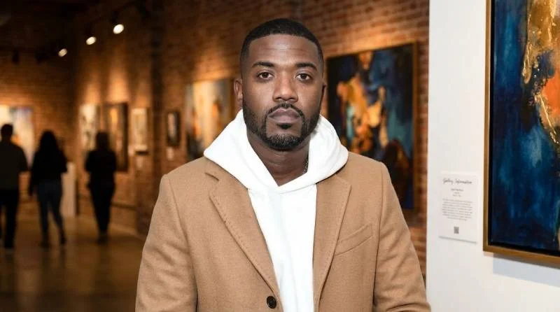Ray J in a recording studio standing at a mixing console